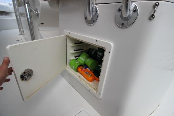 Slide: The Image of Storage compartment on a 2008 Jupiter 34 FS boat with sunscreen and toiletries. - 14