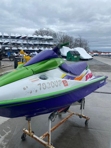 Slide: The Image of 1996 Kawasaki ZXI 900 jet ski in green and purple on a stand. - 3
