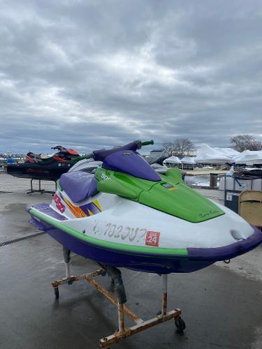 Slide: The Image of 1996 Kawasaki ZXI 900 jet ski in green and purple on a stand. - 4