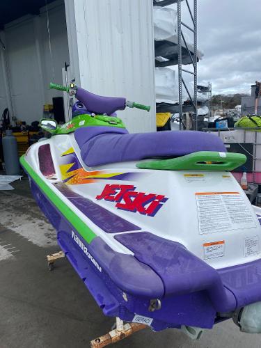 Slide: The Image of 1996 Kawasaki ZXI 900 Jet Ski with vibrant purple and green accents. - 5