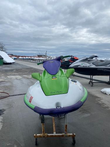 Slide: The Image of 1996 Kawasaki ZXI 900 jet ski in green and purple on a stand. - 6