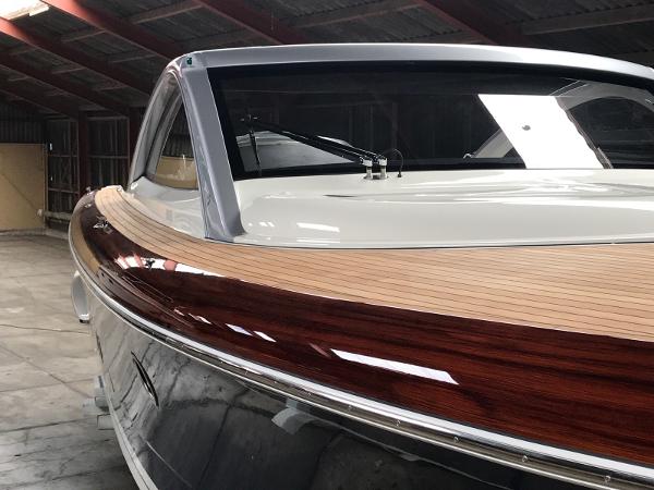 Slide: The Image of 2025 Keizer 42 boat with sleek wooden deck in a warehouse. - 3