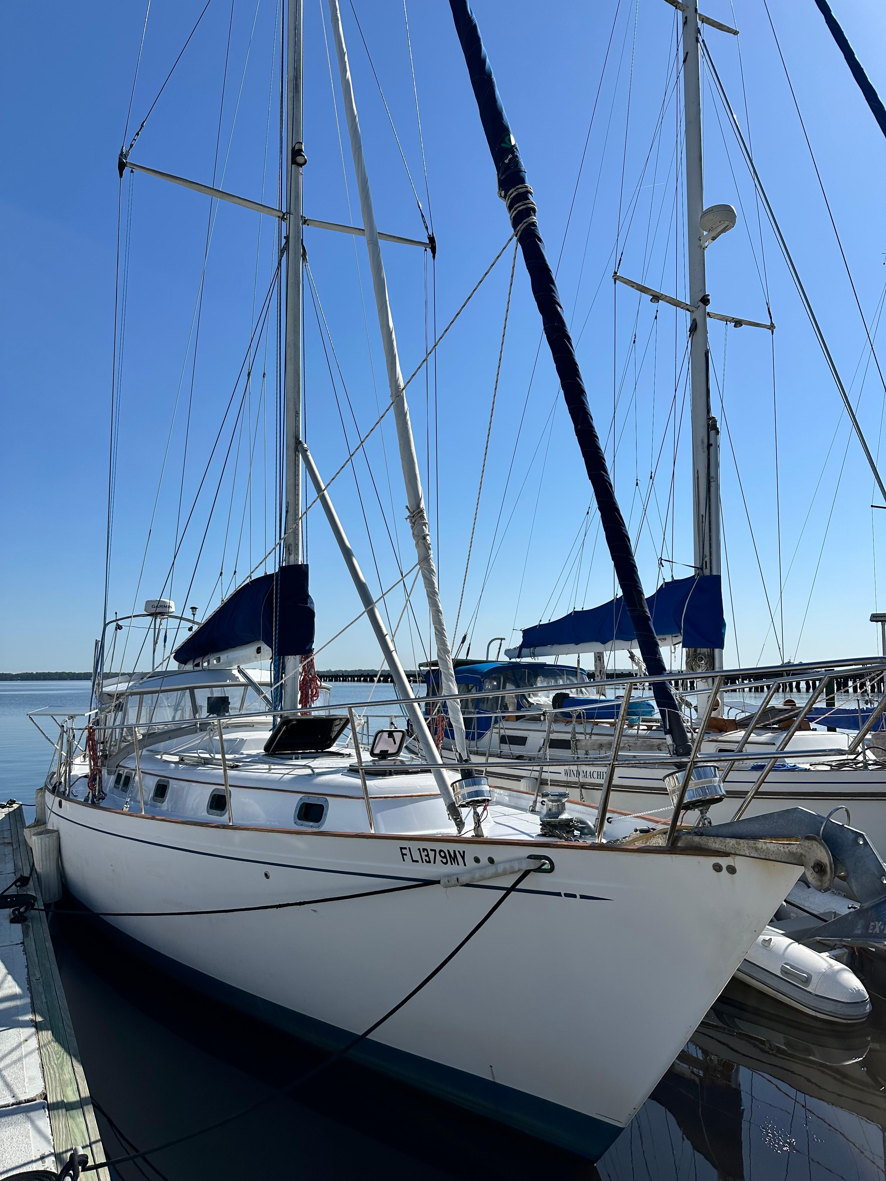 Slide: The Image of 1981 Kelly Peterson 44 sailboat docked at marina under clear blue sky. - 1