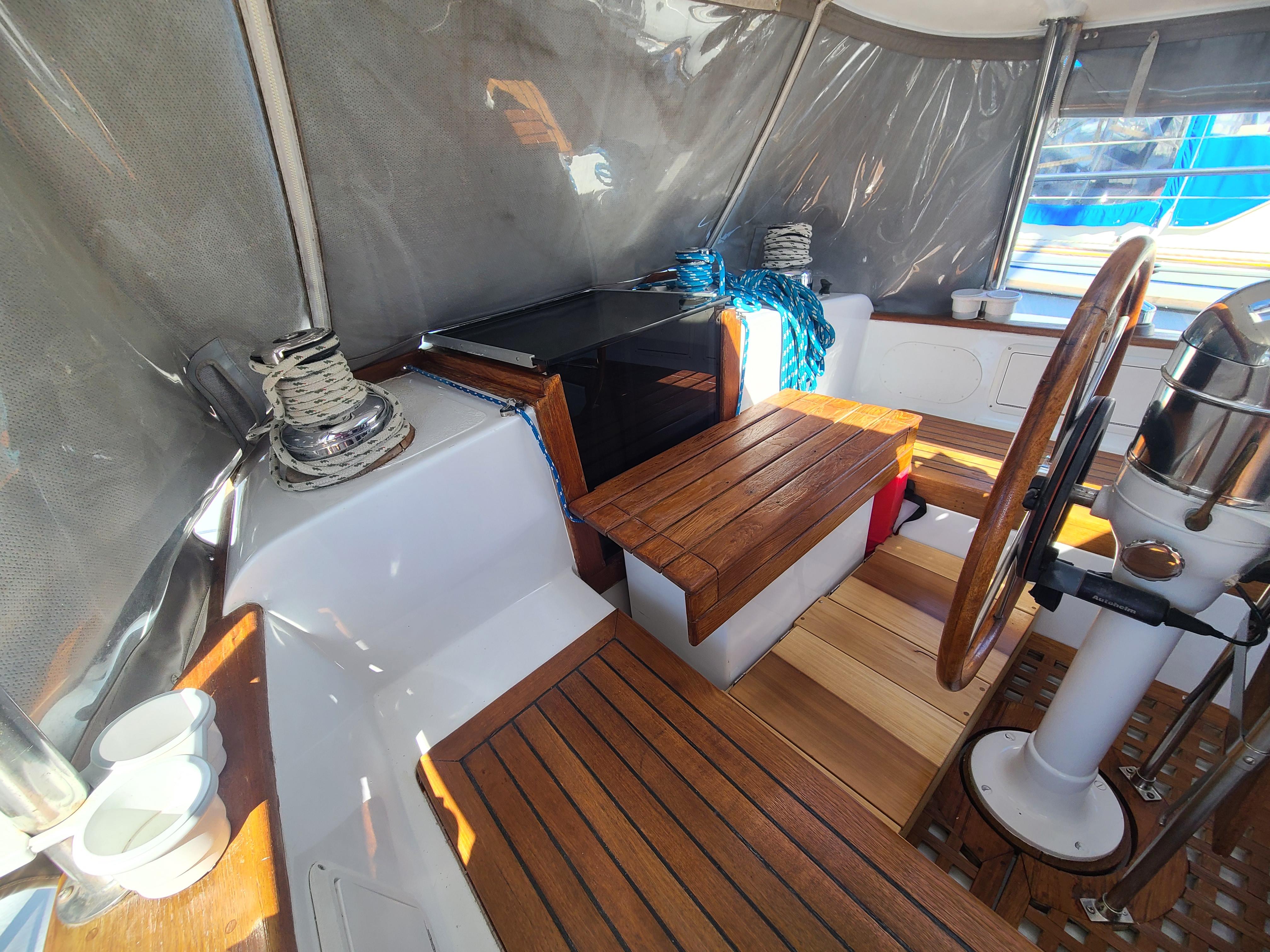 Slide: The Image of Interior of 1981 Kelly Peterson 44 sailboat with wooden seating and steering wheel. - 27