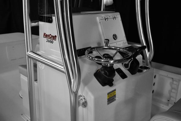 Slide: The Image of KenCraft 2460 Bay Rider Skiff 2025 model boat console with steering wheel and controls. - 7