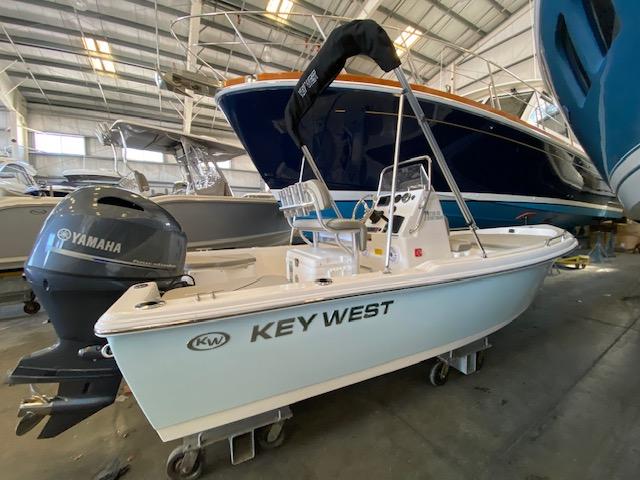 Slide: The Image of 2023 Key West 1720CC boat with Yamaha outboard motor in a storage facility. - 1