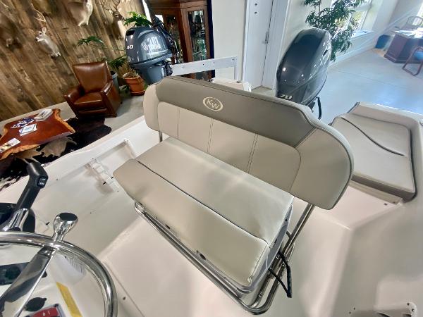 Slide: The Image of 2024 Key West 1720 CC boat interior with cushioned seating and dual outboard motors. - 10
