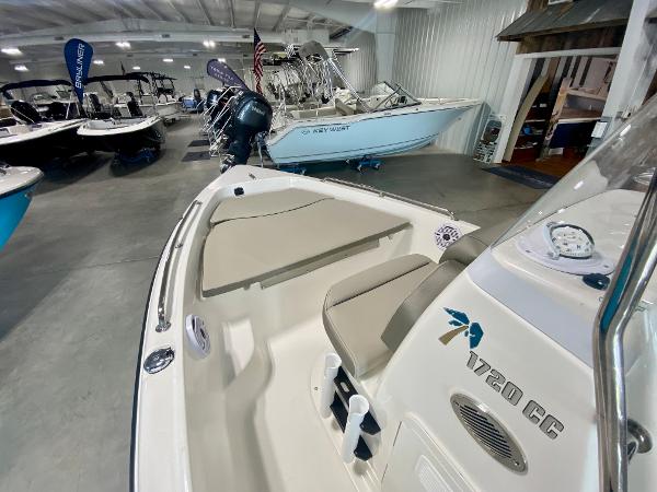 Slide: The Image of 2024 Key West 1720 CC boat displayed in a showroom. - 12