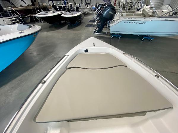 Slide: The Image of 2024 Key West 1720 CC boat interior, bow seating area in showroom. - 14