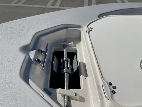 Slide: The Image of Anchor compartment of 2025 Key West 179 FS boat, featuring a neatly stored anchor. - 14