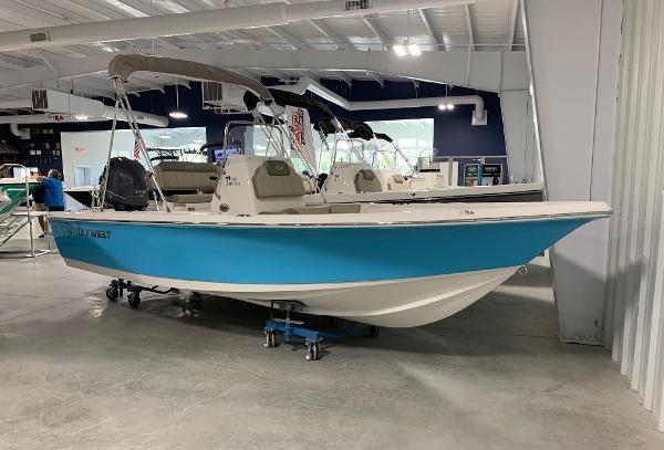 Slide: The Image of 2024 Key West 188 Bay Reef boat displayed in a showroom. - 0