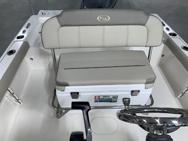 Slide: The Image of 2024 Key West 188 Bay Reef boat interior with cushioned seating and storage. - 10