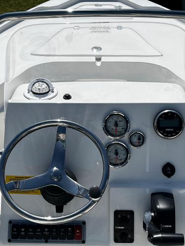 Slide: The Image of 2024 Key West 188 Bay Reef boat dashboard with steering wheel and gauges. - 10