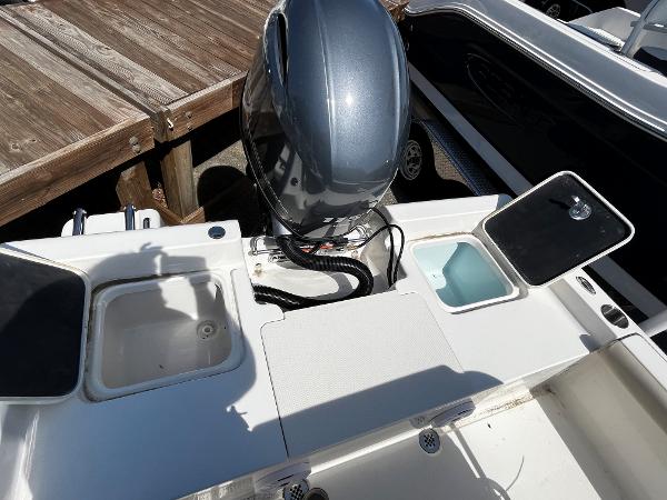 Slide: The Image of 2024 Key West 188 Bay Reef boat stern with motor and storage compartments. - 3