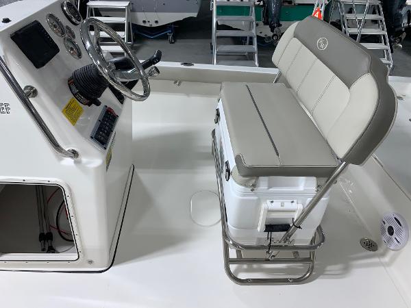 Slide: The Image of 2024 Key West 188 Bay Reef boat interior with steering console and cushioned seating. - 6