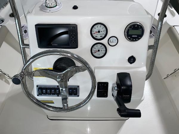 Slide: The Image of 2024 Key West 188 Bay Reef boat console with steering wheel, gauges, and controls. - 7