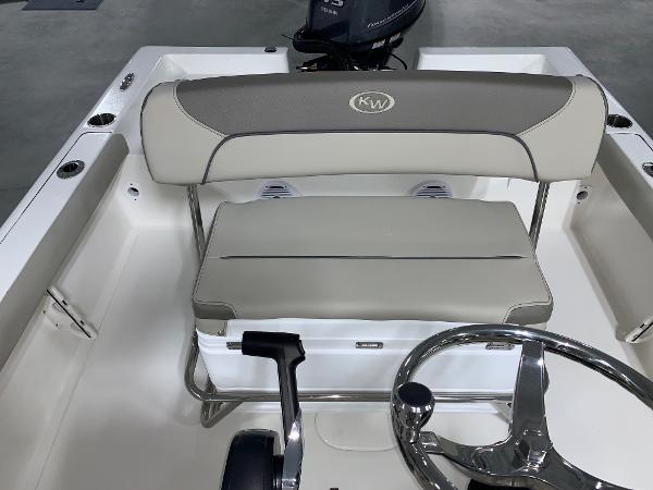 Slide: The Image of 2024 Key West 188 Bay Reef boat interior with steering wheel and cushioned seating. - 8