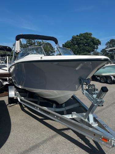 Slide: The Image of 2024 Key West 203 DFS boat on a trailer under clear blue sky. - 1