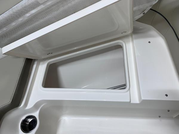 Slide: The Image of Open storage compartment in 2024 Key West 203 DFS boat. - 13