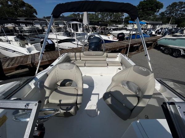 Slide: The Image of 2024 Key West 203 DFS boat interior with seating, docked among other boats. - 5