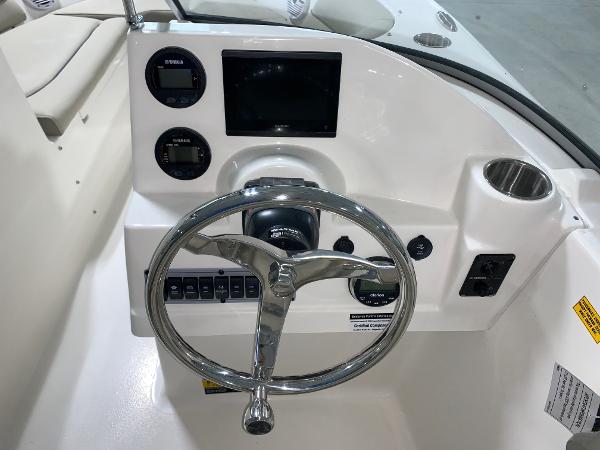 Slide: The Image of 2024 Key West 203 DFS boat dashboard with steering wheel and control panel. - 8