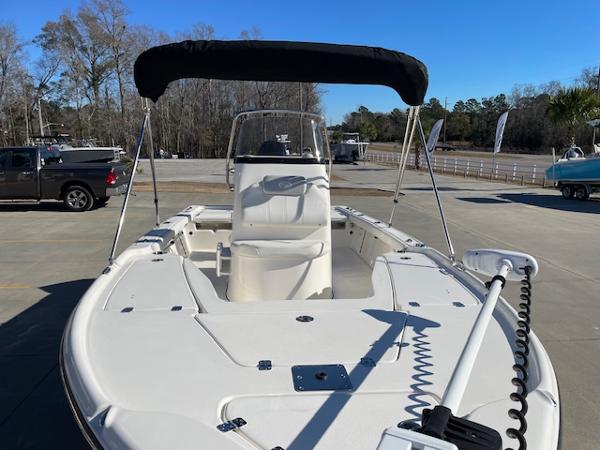 Slide: The Image of 2023 Key West 210 Bay Reef boat with bimini top in a parking lot. - 4