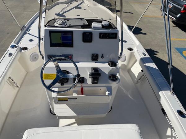 Slide: The Image of 2023 Key West 210 Bay Reef boat interior with steering wheel and control panel. - 9