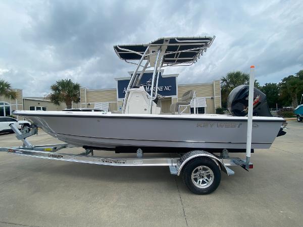 Slide: The Image of 2024 Key West 210 Bay Reef boat on trailer, parked outside dealership. - 0