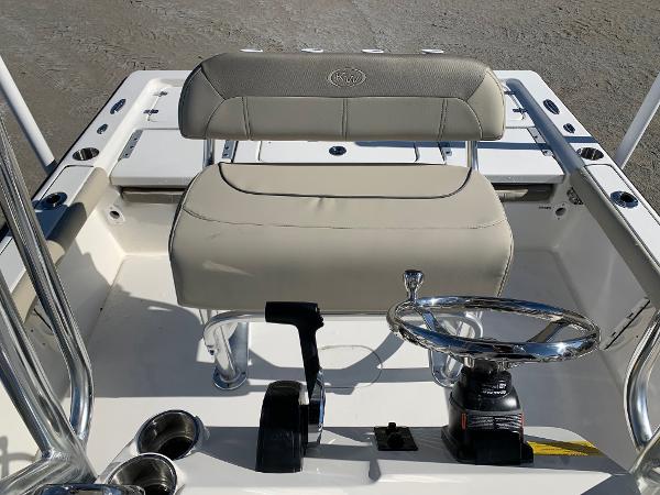 Slide: The Image of 2024 Key West 210 Bay Reef boat interior with steering wheel and seating. - 13
