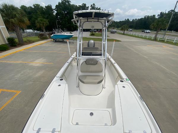 Slide: The Image of 2024 Key West 210 Bay Reef boat, front view, parked on concrete. - 24