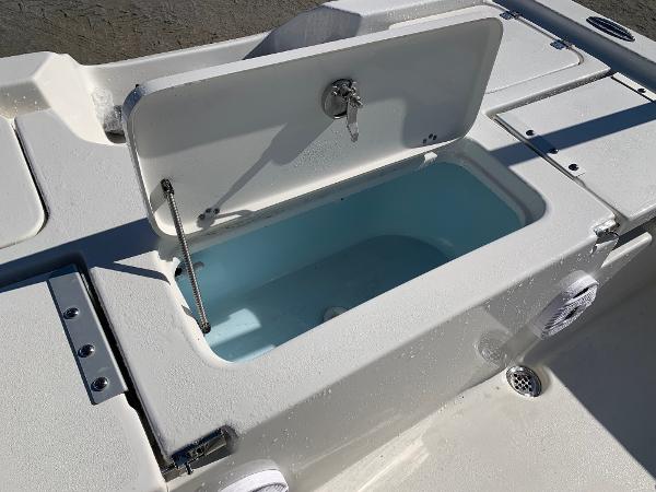 Slide: The Image of 2024 Key West 210 Bay Reef boat livewell compartment with open lid. - 4