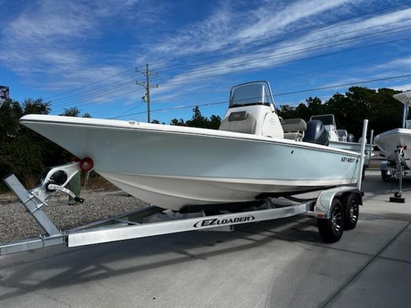 Slide: The Image of 2025 Key West 210 Bay Reef boat on EZ Loader trailer, parked outdoors. - 10