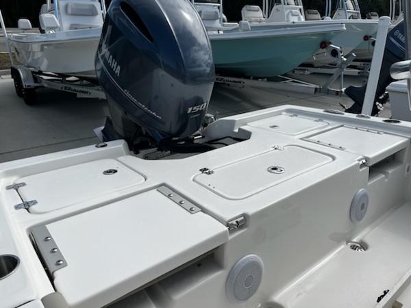 Slide: The Image of 2025 Key West 210 Bay Reef boat with Yamaha 150 engine, docked outdoors. - 17