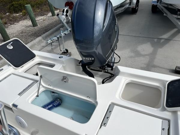 Slide: The Image of 2025 Key West 210 Bay Reef boat with outboard motor and storage compartments. - 18