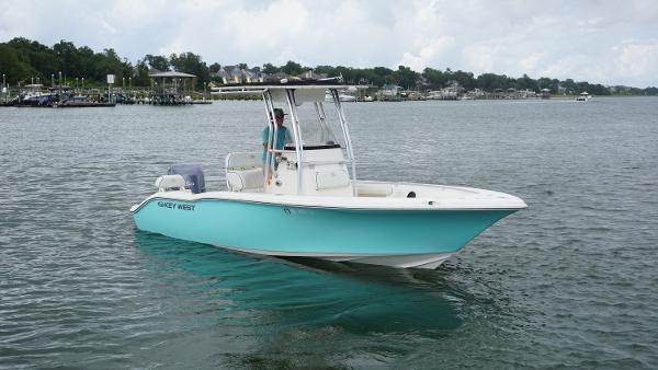 The Image of 2008 Key West 211 Bluewater boat on calm water, with a person at the helm. - 1