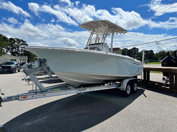 Slide: The Image of 2024 Key West 219 FS boat on a trailer under a blue sky. - 0