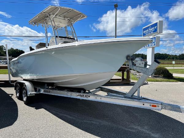 Slide: The Image of 2026 Key West 219 FS boat on trailer under clear blue sky. - 1