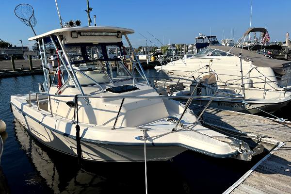 Slide: The Image of 2005 Key West 2300 WA boat docked at a marina. - 3