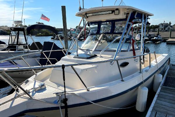 Slide: The Image of 2005 Key West 2300 WA boat docked at a marina. - 5