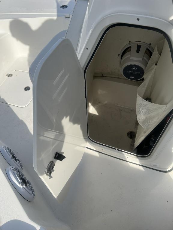 Slide: The Image of Open storage compartment on 2022 Key West 230 BR boat, showing interior space and speaker. - 2