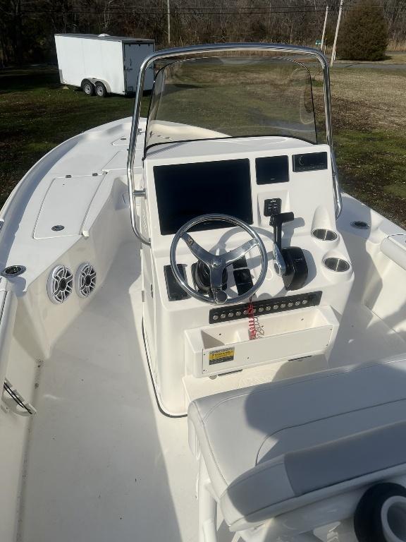 Slide: The Image of 2022 Key West 230 BR boat interior with steering console and seating. - 3