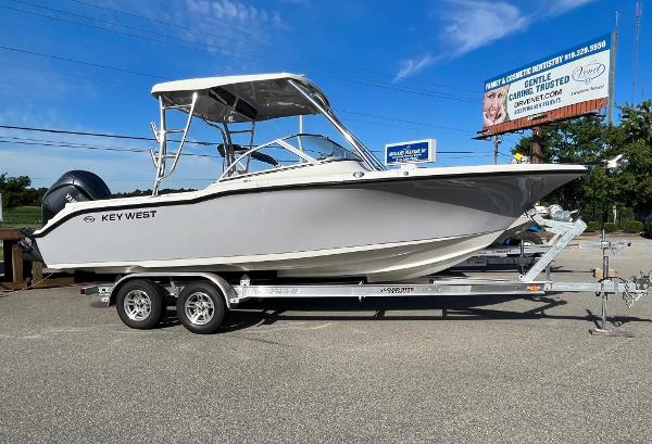 Slide: The Image of 2024 Key West 239 DFS boat on a trailer under a clear blue sky. - 0