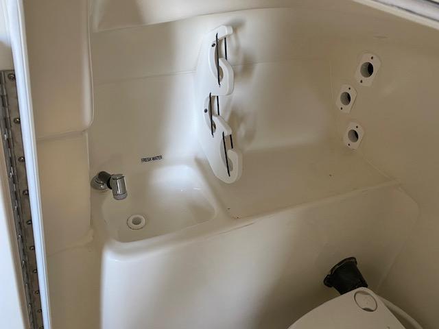 Slide: The Image of 2024 Key West 239 DFS boat interior with sink and storage compartments. - 10