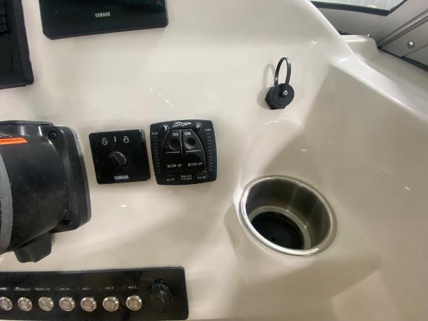 Slide: The Image of 2024 Key West 239 DFS boat dashboard with controls and cup holder. - 17