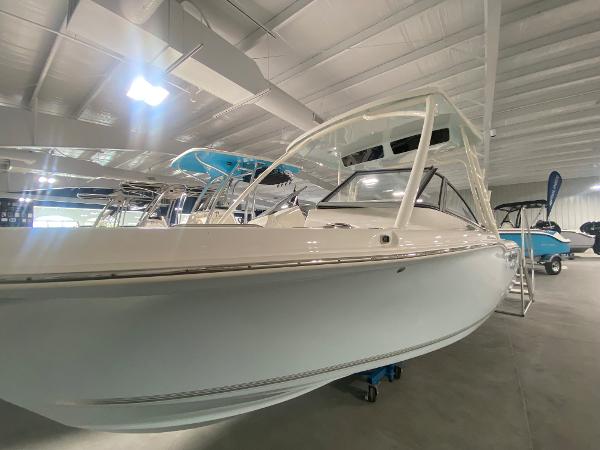 Slide: The Image of 2024 Key West 239 DFS boat displayed in an indoor showroom. - 2