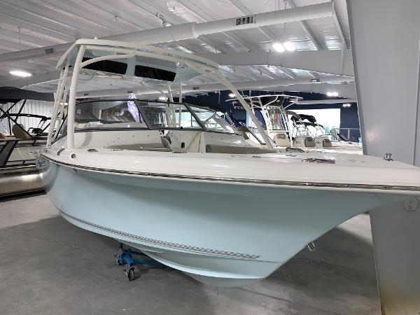 Slide: The Image of 2024 Key West 239 DFS boat displayed in a showroom. - 2