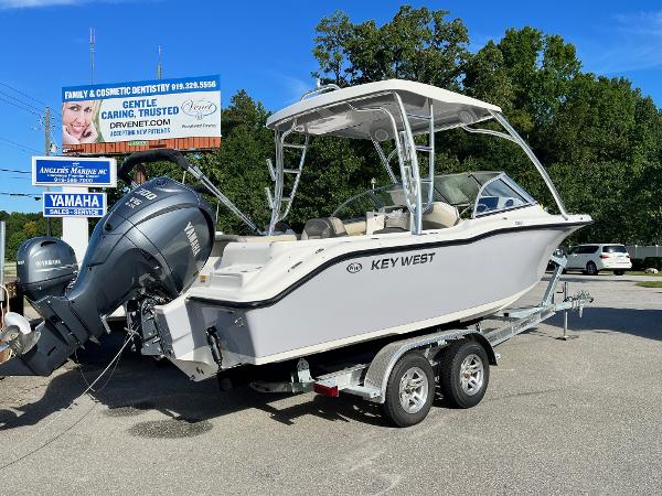 Slide: The Image of 2024 Key West 239 DFS boat on a trailer with Yamaha outboard engines. - 2