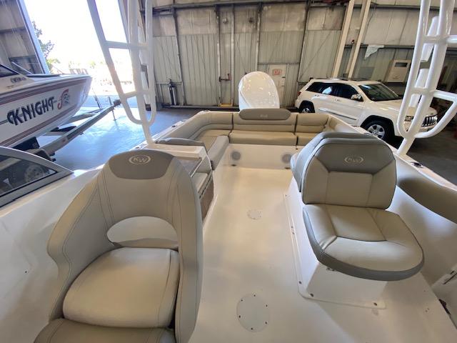 Slide: The Image of 2024 Key West 239 DFS boat interior with beige seating in a showroom. - 5