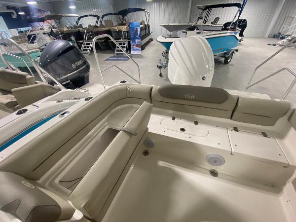 Slide: The Image of 2024 Key West 239 DFS boat interior with beige seating in a showroom. - 5