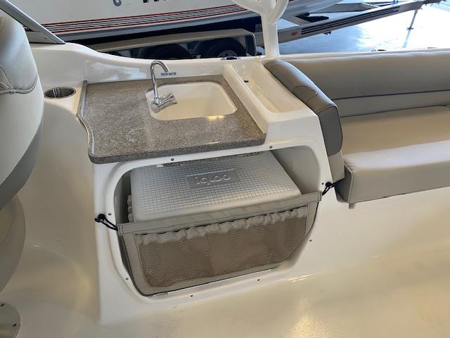 Slide: The Image of 2024 Key West 239 DFS boat interior with sink and cooler storage. - 6